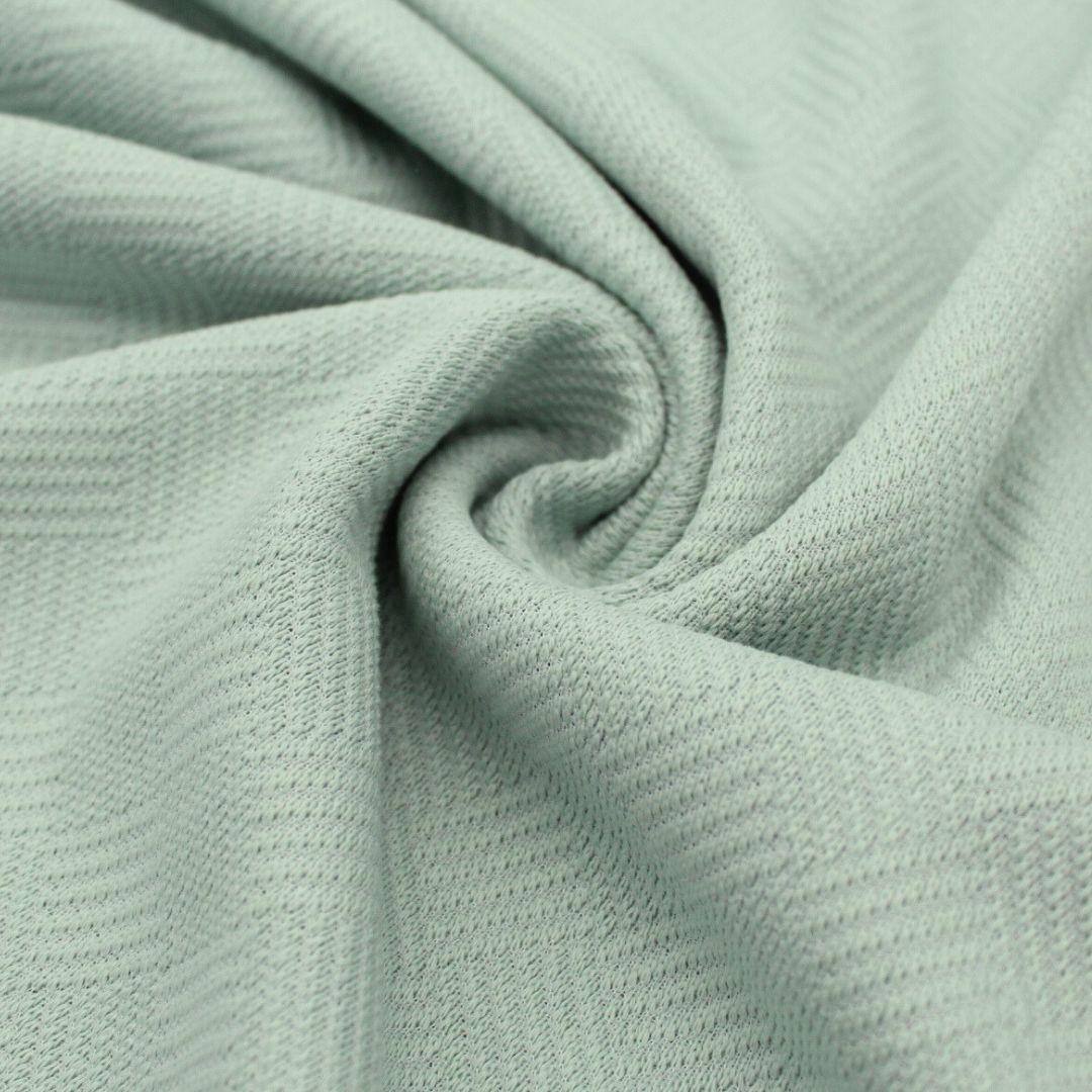 Baumwolljacquard-Mix in Pastellgrün – Weicher Stoff mit leichter Elastizität, perfekt für bequeme Hosen und Accessoires.