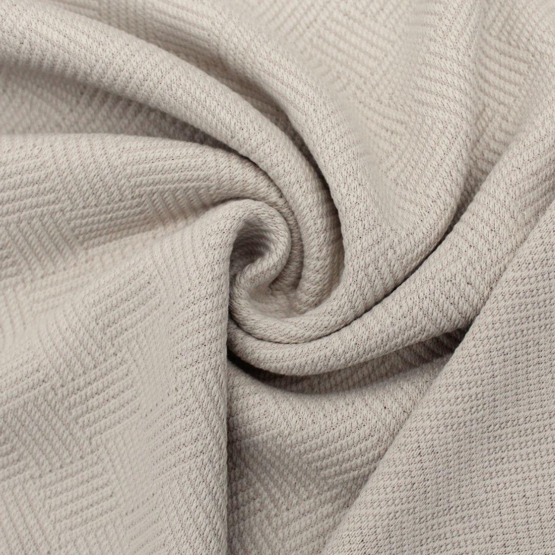 Nahtdetail von Baumwolljacquard-Stoff in Sand – Strukturierte Oberfläche für stylische Nähprojekte und Heimtextilien.