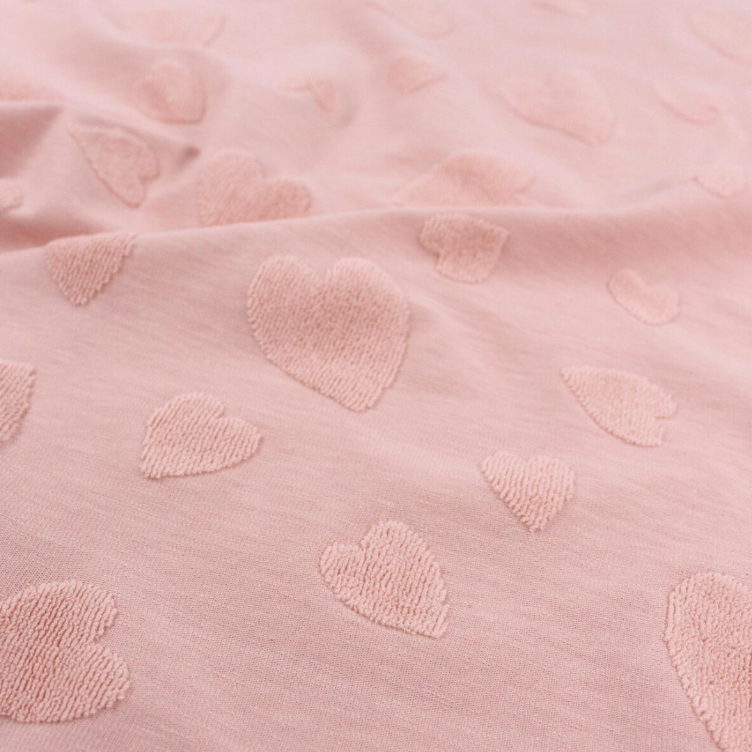 Detailaufnahme Jacquard-Textur mit Frottee-Herzen in zartem Puderrosa