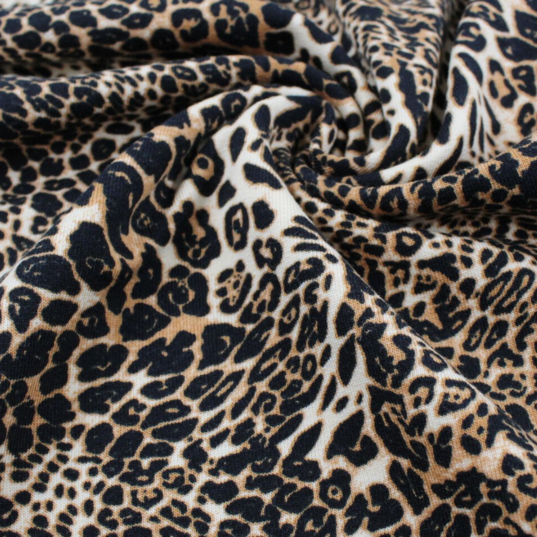 French Terry angeraut – modischer Stoff in Beige und Schwarz mit Wildtiermuster