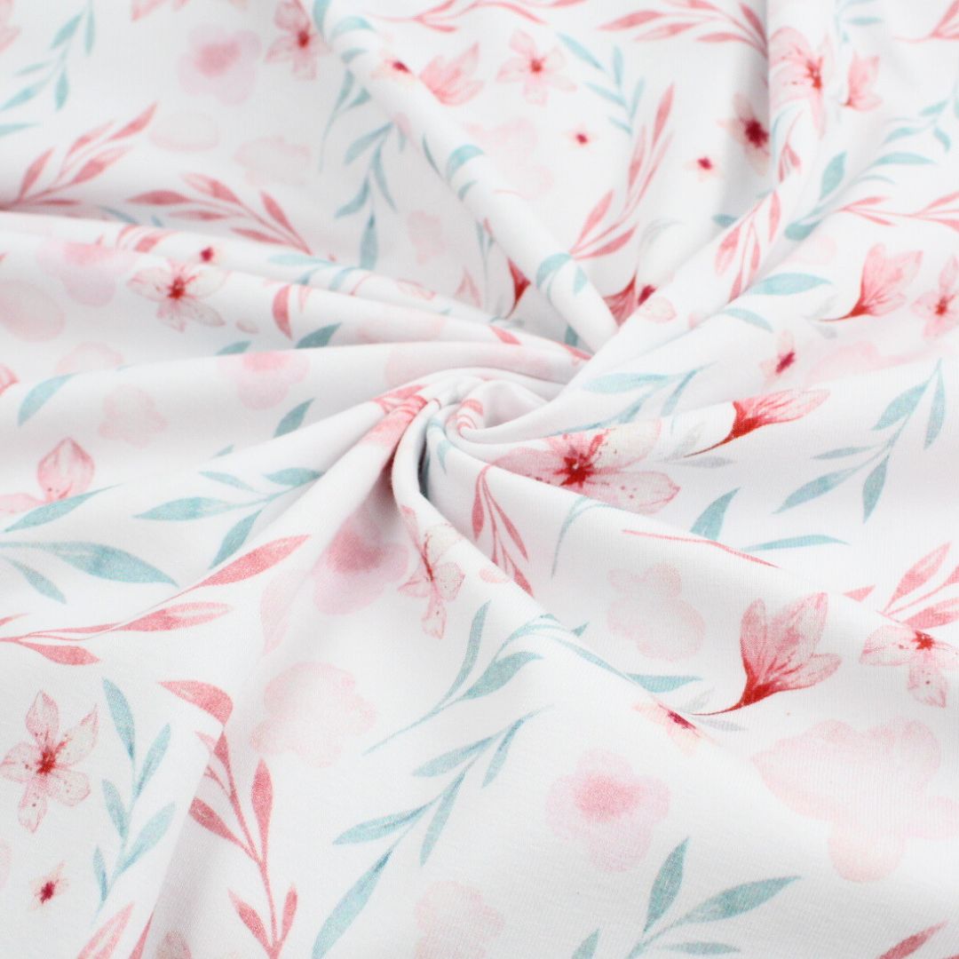 Baumwolljersey mit floralem Muster in Rosa und Blau – weicher, dehnbarer Stoff für Kindermode und Accessoires