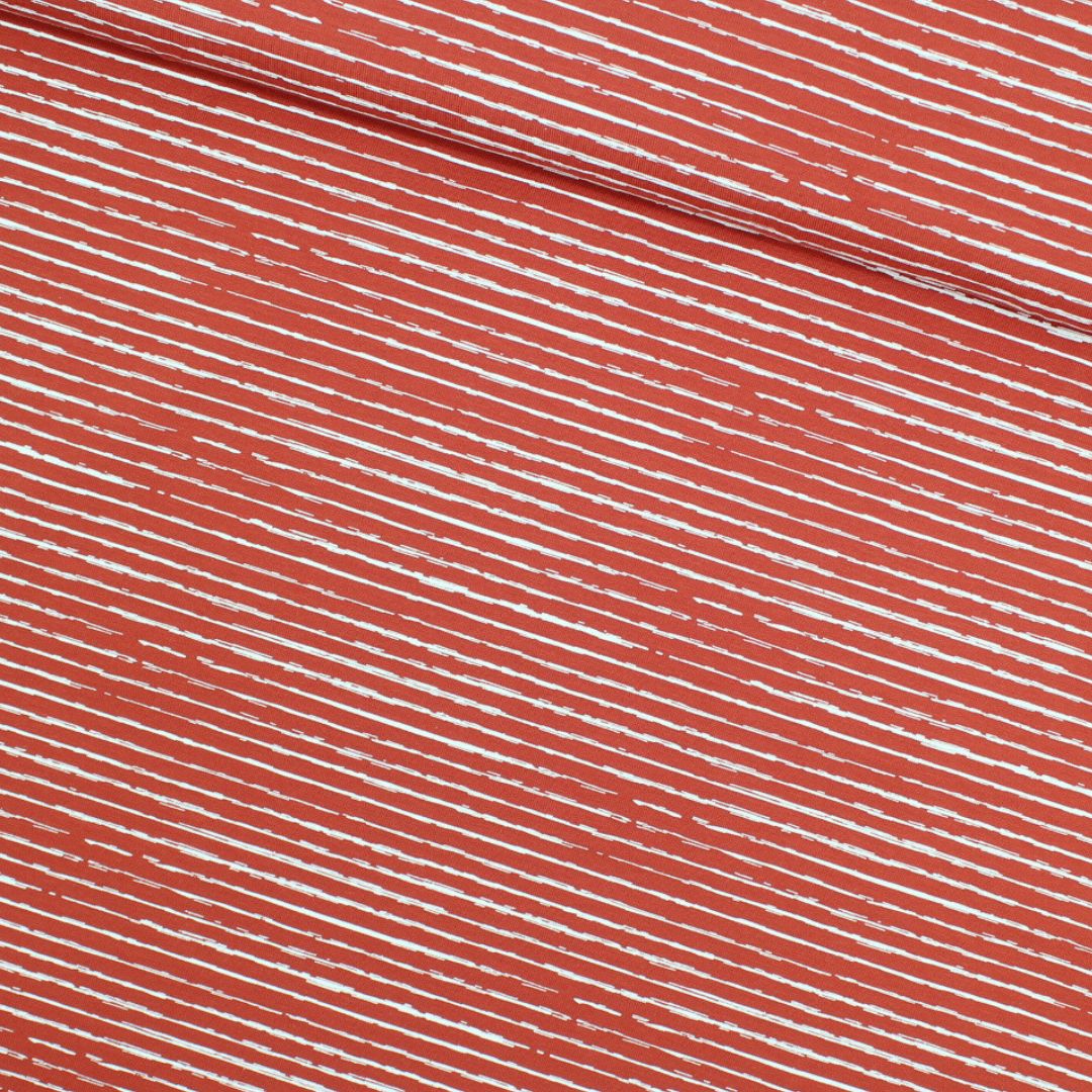 Jersey-Stoff mit weißen unregelmäßigen Streifen, ideal für Kleidung und modische Nähprojekte