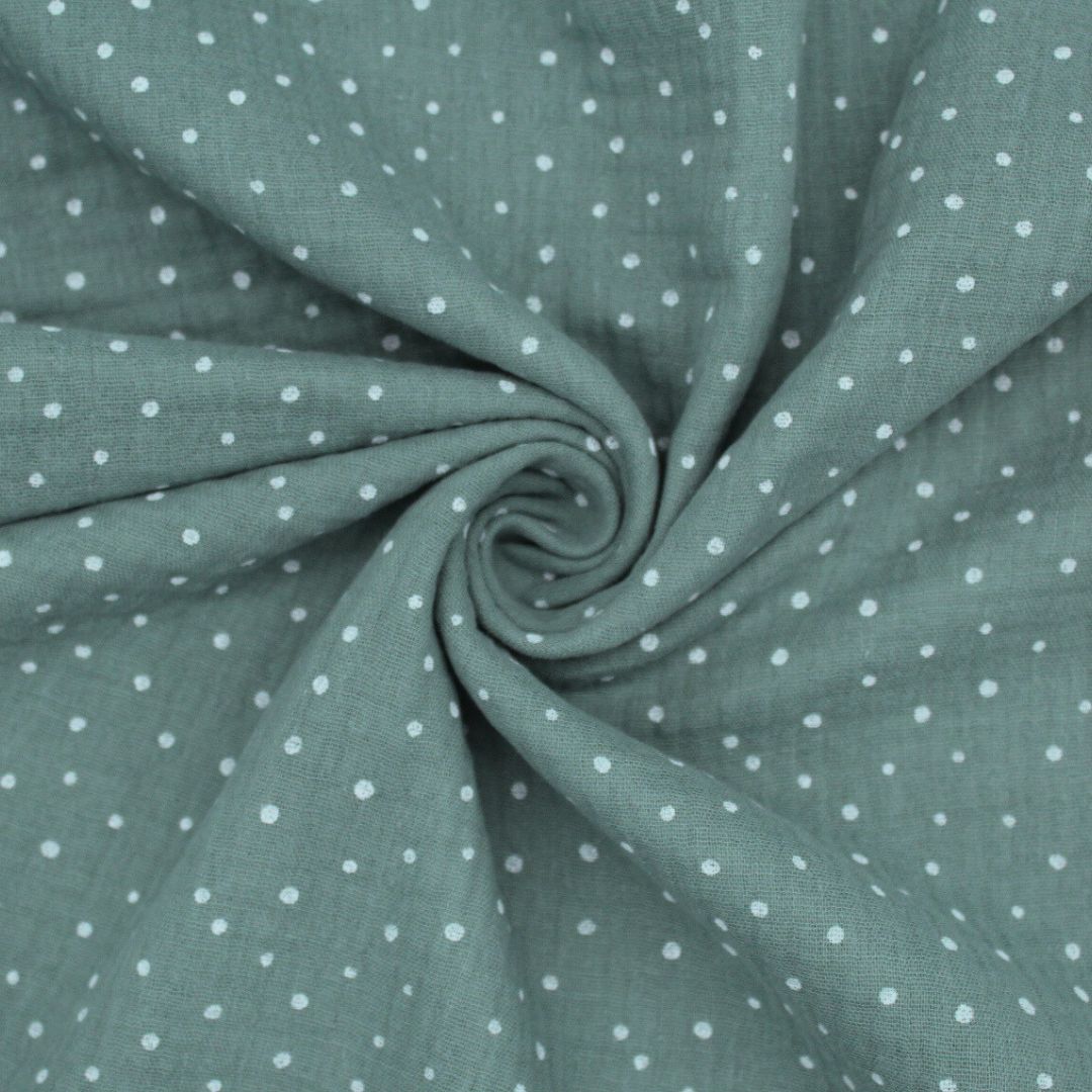 Gefalteter Musselinstoff mit zarten weißen Punkten, weicher Griff und eleganter Fall. Farbe: Grün