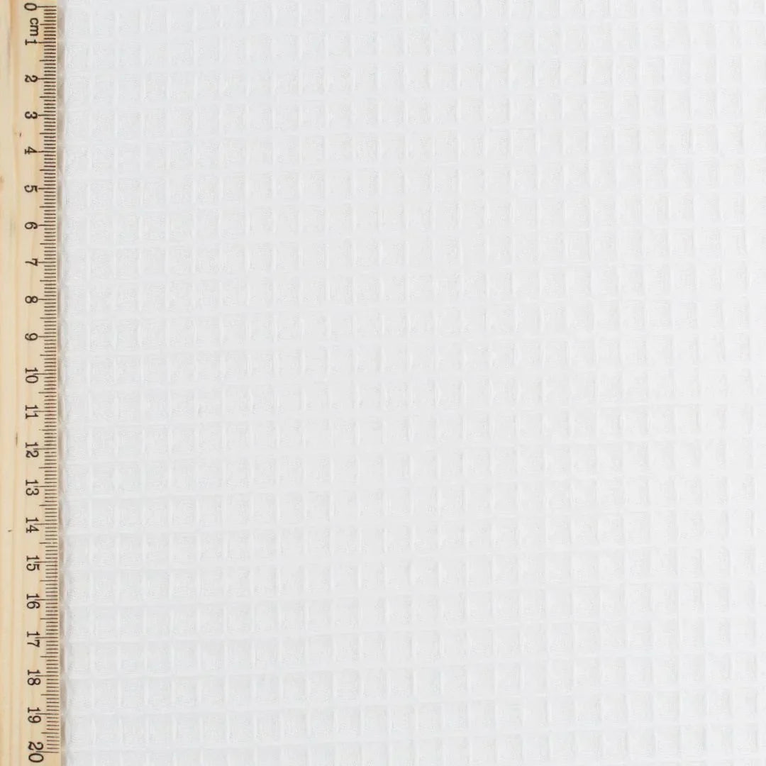 Strukturierter Waffelstoff in Ecru, ideal für Heimtextilien, Bekleidung und Babyartikel. Lineal