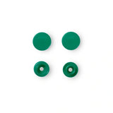 Nahaufnahme der grasgrünfarbenen Druckknöpfe, die ihre runde Form und Farbe zeigen, ideal für Baby- und Kinderbekleidung.