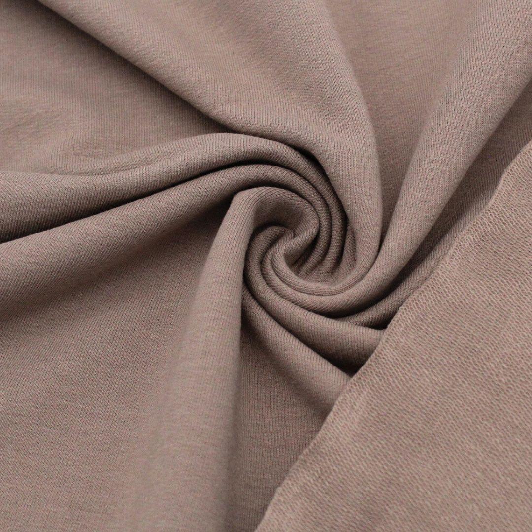 Detailansicht des nicht angerauten French Terry-Stoffs, ideal für die Herstellung von Sweatshirts und Freizeitkleidung.
