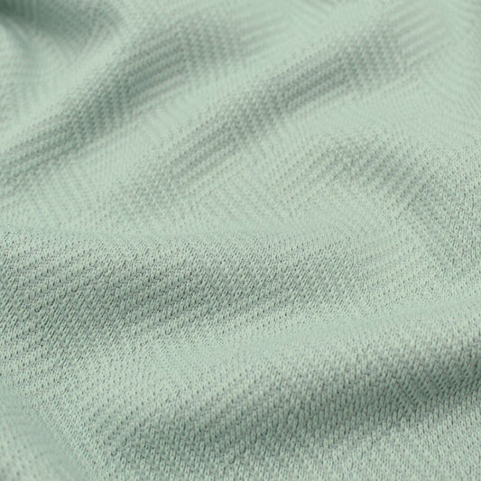 Baumwolljacquard-Stoff in Pastellgrün – Detailaufnahme der gewebten Struktur und Muster