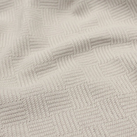 Baumwolljacquard-Stoff in Sand – Detailaufnahme der gewebten Struktur und Muster.