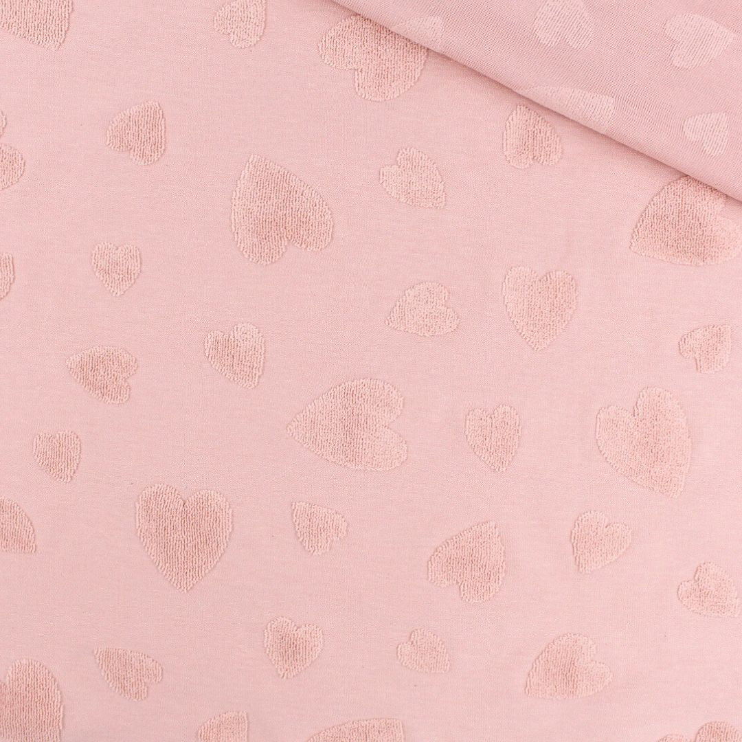 Baumwoll-Jacquard Stoff mit Frottee-Herzen in Puderrosa, Nahaufnahme der Struktur