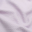 Leichte Baumwolle mit Bienenwaben-Jacquard-Struktur, ideal für die Herstellung von Sommerblusen, Tops und Kleidern – strapazierfähig und pflegeleicht. Pastell Lila
