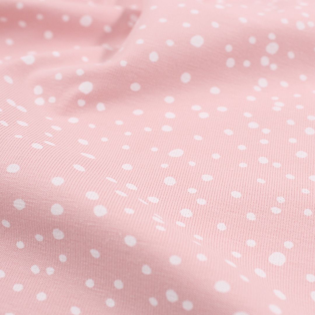 Detailansicht Jersey weiße Punkten auf Rosa Hintergrund