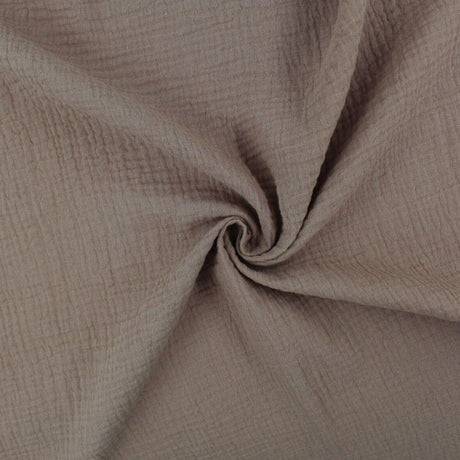 Weicher Musselinstoff (Double Gauze) in Taupe, locker drapiert, mit natürlicher Crinkle-Struktur und sanftem Fall.