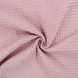Fein gewebter Waffelstoff in zartem Rosa-Ton, ideal für Heimtextilien und Bekleidung.