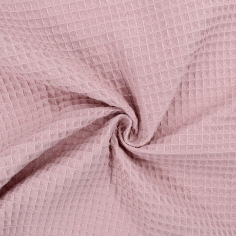 Fein gewebter Waffelstoff in zartem Rosa-Ton, ideal für Heimtextilien und Bekleidung.