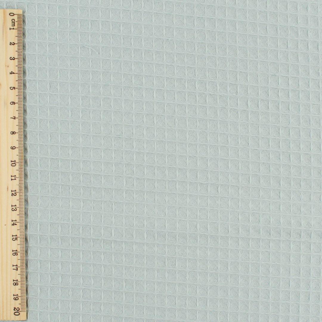 Fein gewebter Waffelstoff in zartem Mintgrün-Ton, ideal für Heimtextilien und Bekleidung.